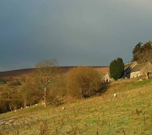 A view of the uplands in the Black Mountains, south Wales with buildings in the foreground